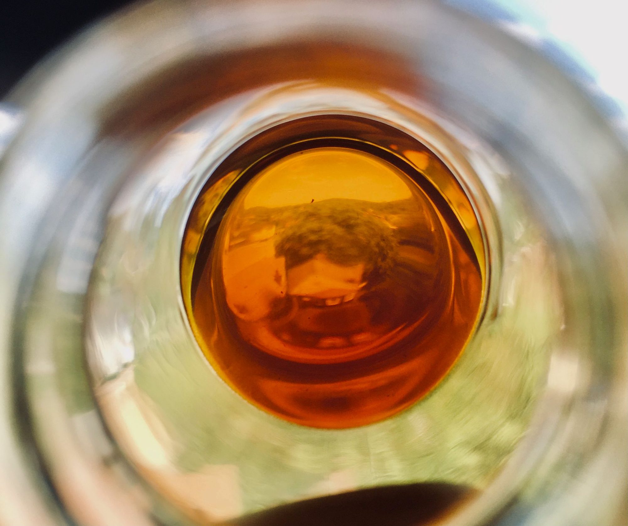 Clear amber oil seen through a glass flask