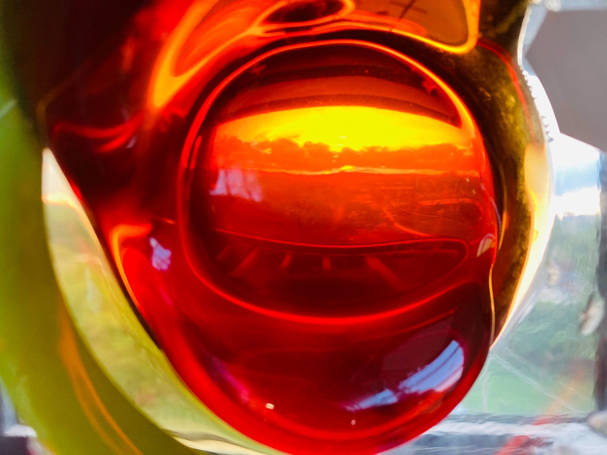 Dewaxed oil glowing amber in a glass flask